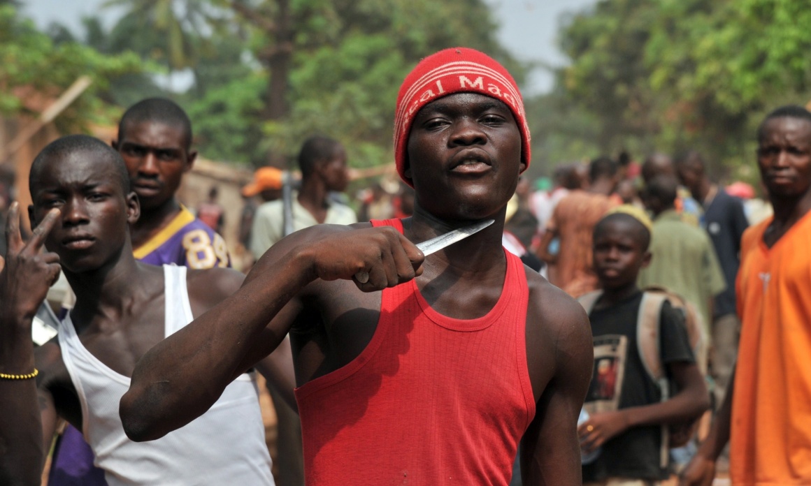 A man holds a knife to his throat claiming that he is looking for Muslims to cut off their heads in the 5th district of Bangui on February 9, 2014. According to witnesses, at least ten people have been killed since the night before in central Bangui, and many buildings burned, after violence broke out near the district hall of Bangui's 5th district. Large-scale looting was also taking place in the same neighbourhood in the morning of February 9 despite the deployment of French troops and Central African gendarmes. The International Criminal Court in the Hague said on February 7 it had opened an initial probe into war crimes in the Central African Republic. AFP PHOTO/ ISSOUF SANOGOISSOUF SANOGO/AFP/Getty Images